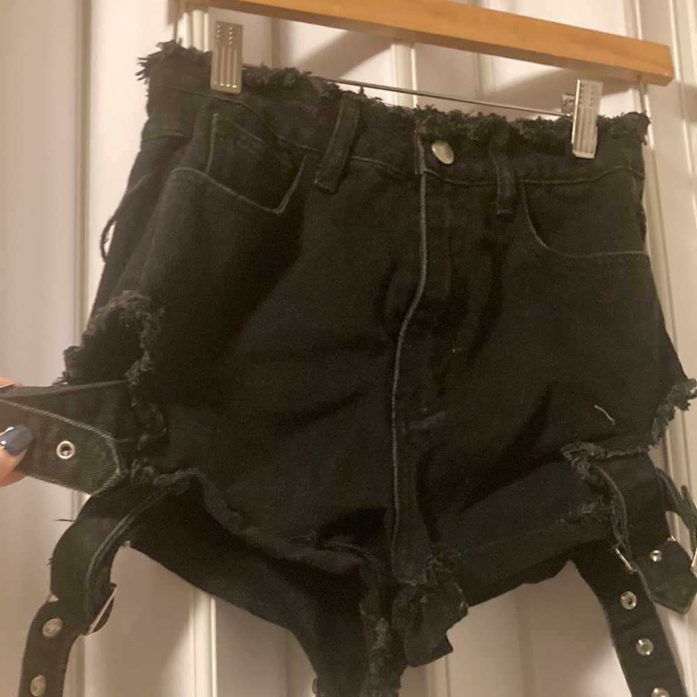 Black distressed denim shorts with buckles